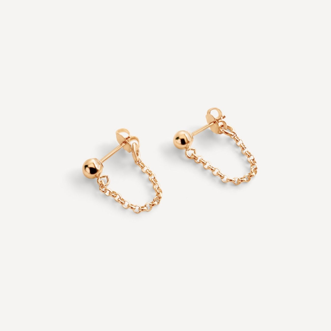 Hudson Earrings in gold fill, featuring a modern stud design with delicate links, displayed on a white background.