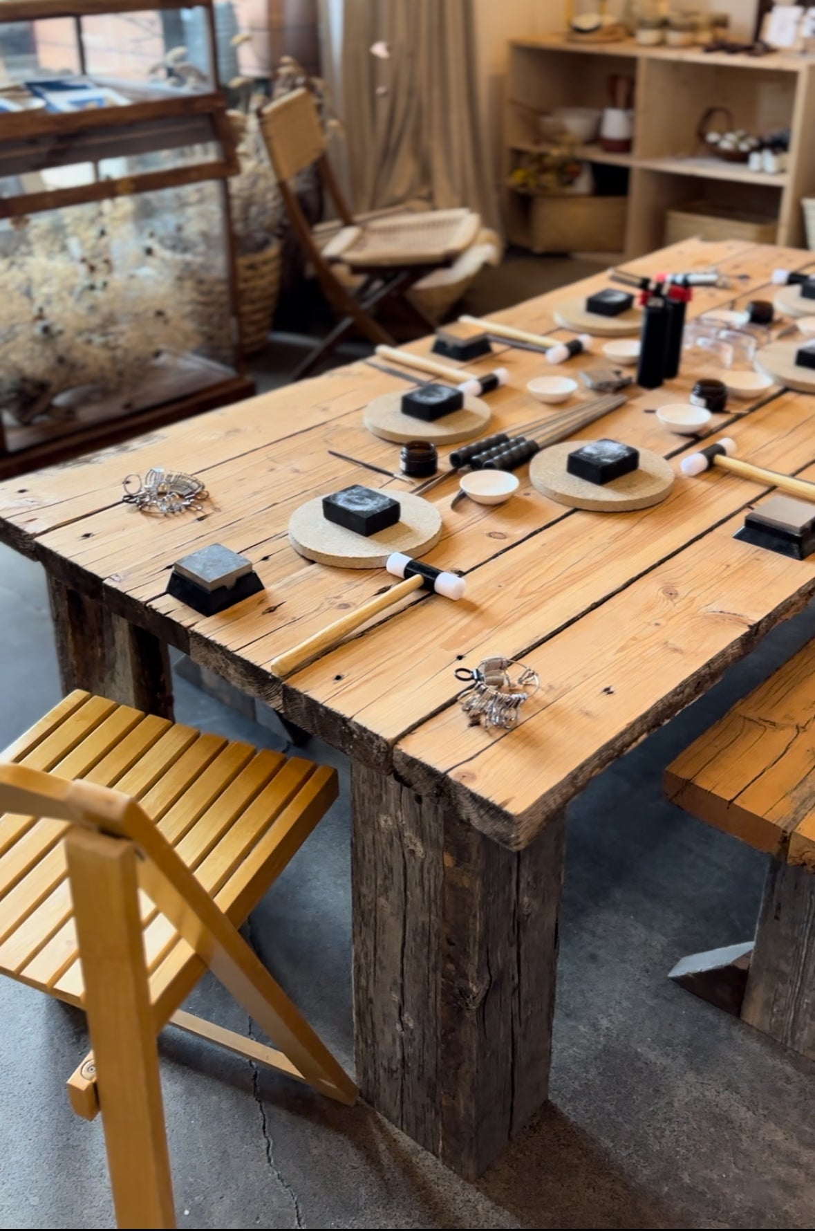 A workspace with jewelry-making tools and materials arranged neatly on a desk.