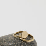 Knife Edge Ring, Solid 14k Gold displayed with other rings on a stone