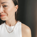 Model wearing the Lola Chunky Paperclip Chain in gold fill, styled as a statement necklace with a modern, layered look.