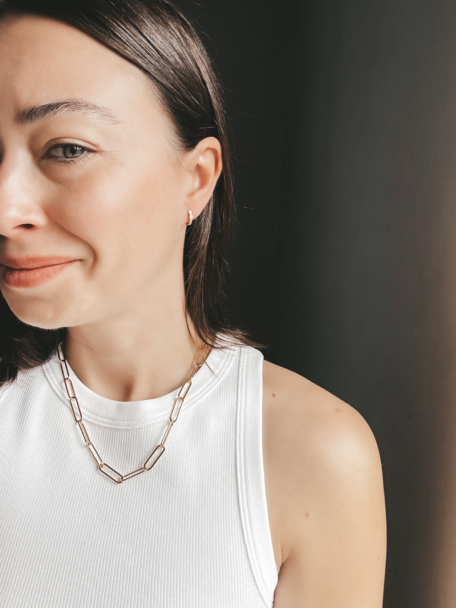 Model wearing the Lola Chunky Paperclip Chain in gold fill, styled as a statement necklace with a modern, layered look.