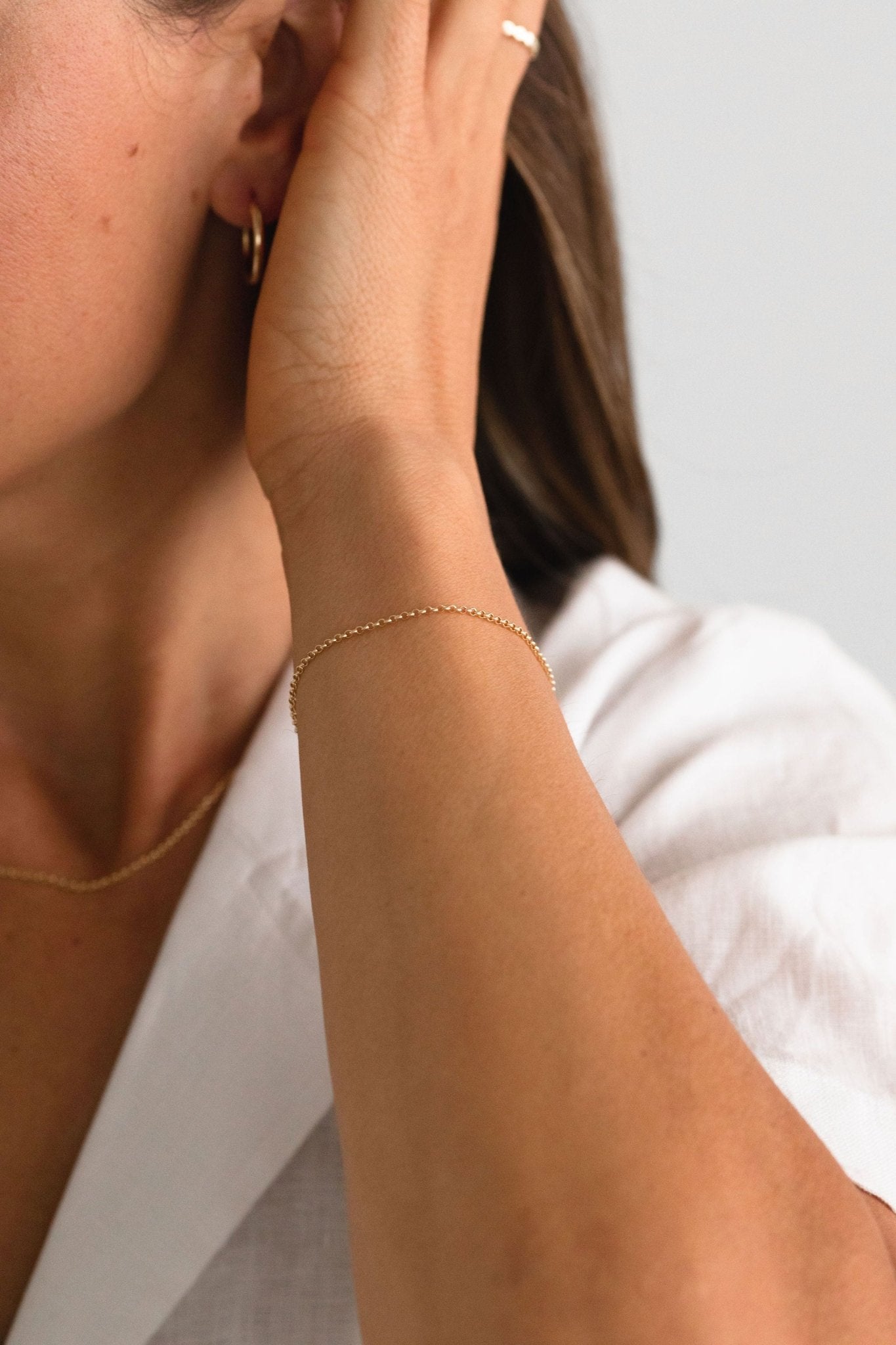 Model layering a gold-filled bracelet by Sheena Marshall Jewelry for an effortlessly elegant look.