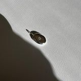 Molten Form Pendant Necklace No. 2, Sterling Silver — pendant close-up on linen