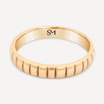 Hand-cast Fairmined 14k solid gold Notch Band featuring subtle notches, shown flat on a clean background.