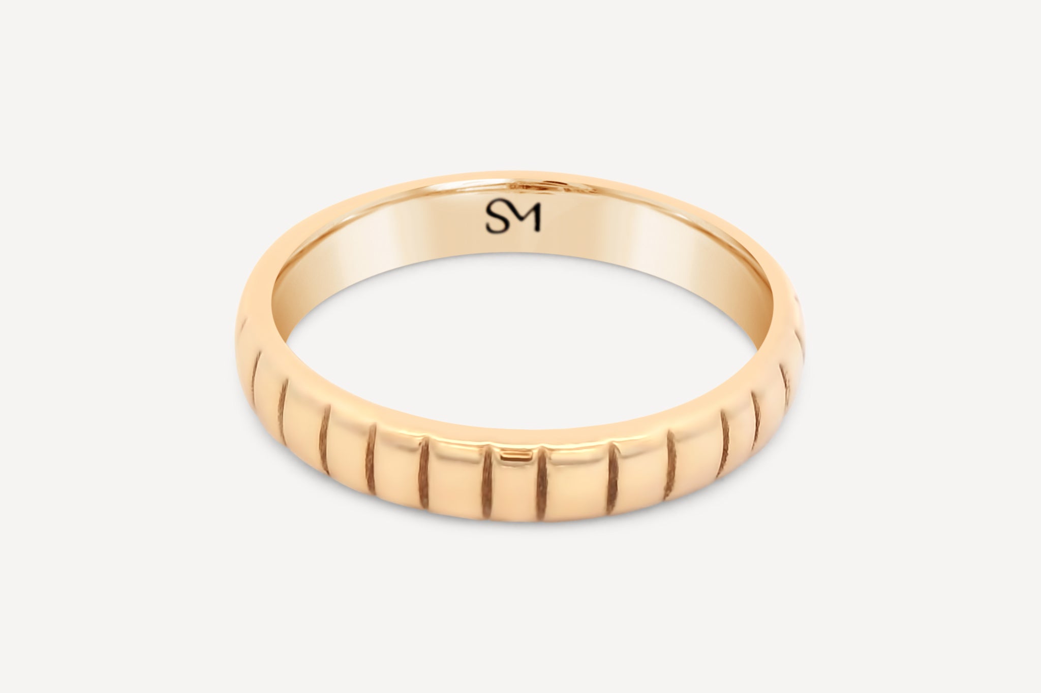 Hand-cast Fairmined 14k solid gold Notch Band featuring subtle notches, shown flat on a clean background.