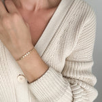 Model wearing Petite Disc Bracelet in gold fill by Sheena Marshall Jewelry, featuring delicate, light-catching discs for a refined and subtle style.