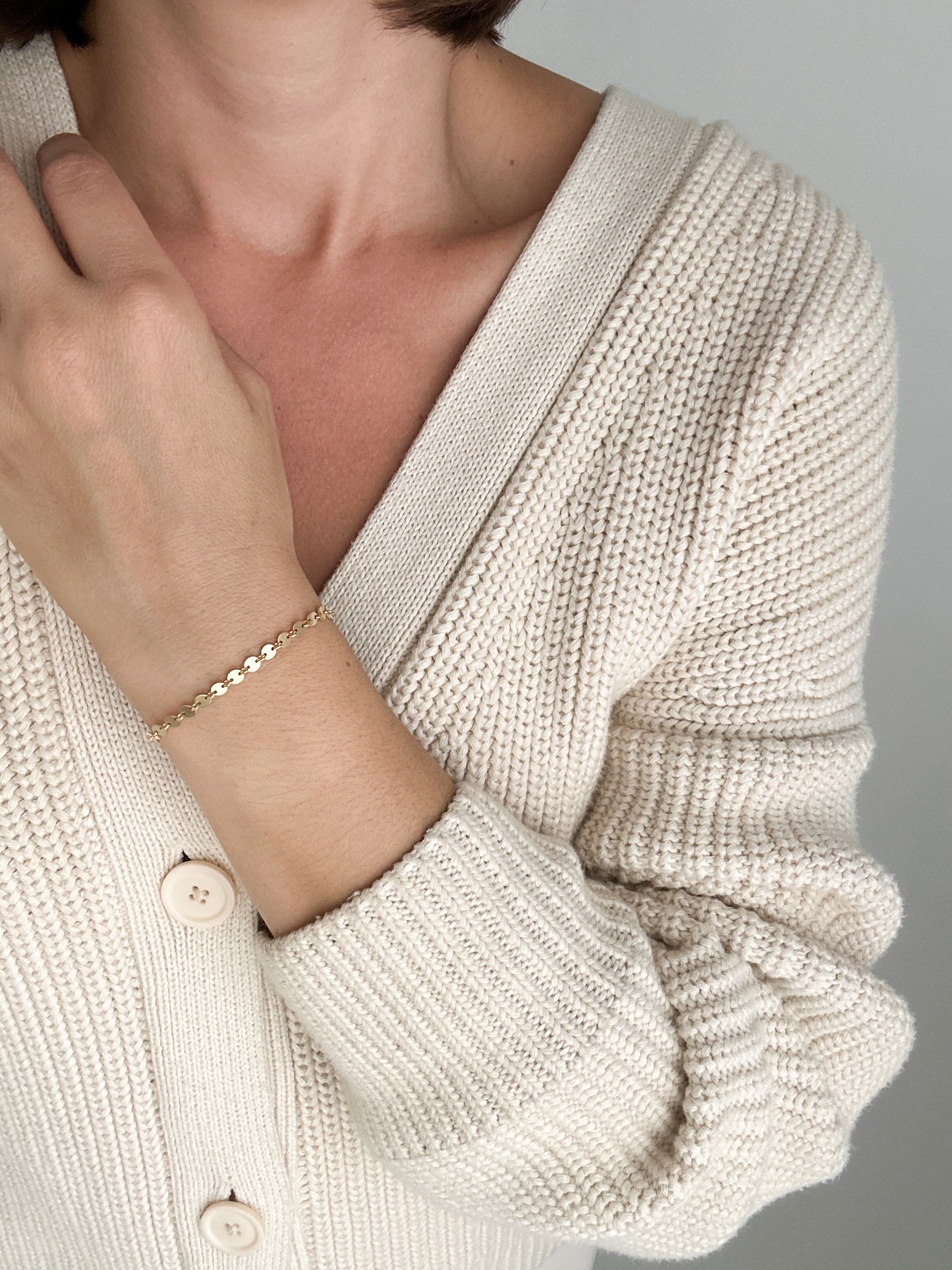 Model wearing Petite Disc Bracelet in gold fill by Sheena Marshall Jewelry, featuring delicate, light-catching discs for a refined and subtle style.