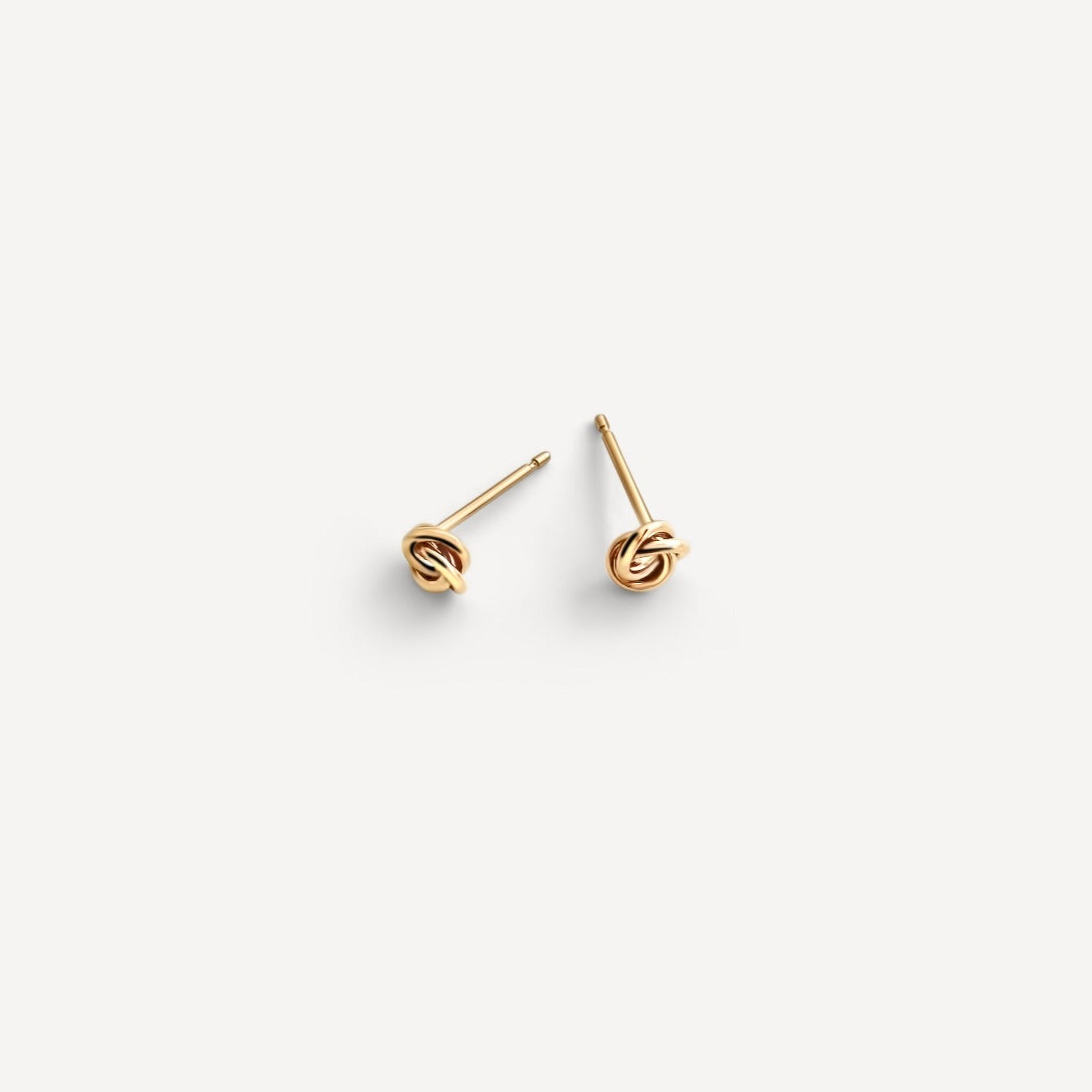 Petite Knot Studs crafted in 14k gold fill, displayed on a white background.