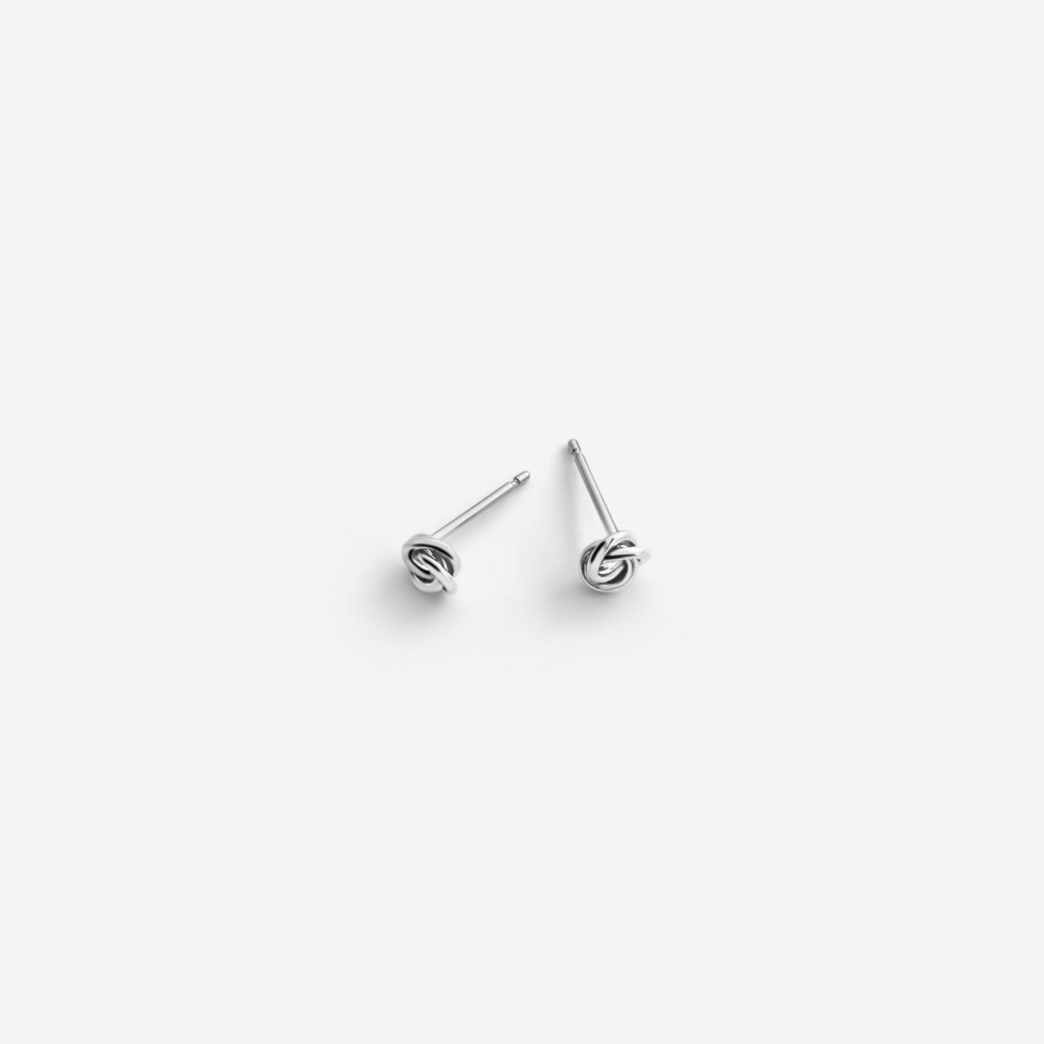 Petite Knot Studs crafted in sterling silver, displayed on a clean white background.