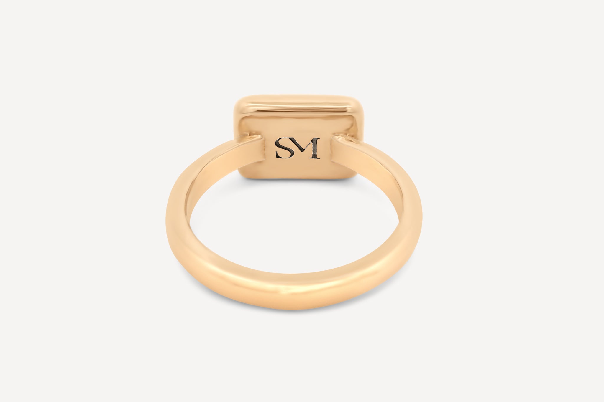 Close-up of the interior of the brass rectangle ring, featuring the stamped SM logo for added detail.