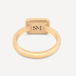 Close-up of the interior of the brass rectangle ring, featuring the stamped SM logo for added detail.