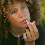 Rose Tallow Lip Balm being applied to lips