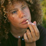 Rose Tallow Lip Balm being applied to lips