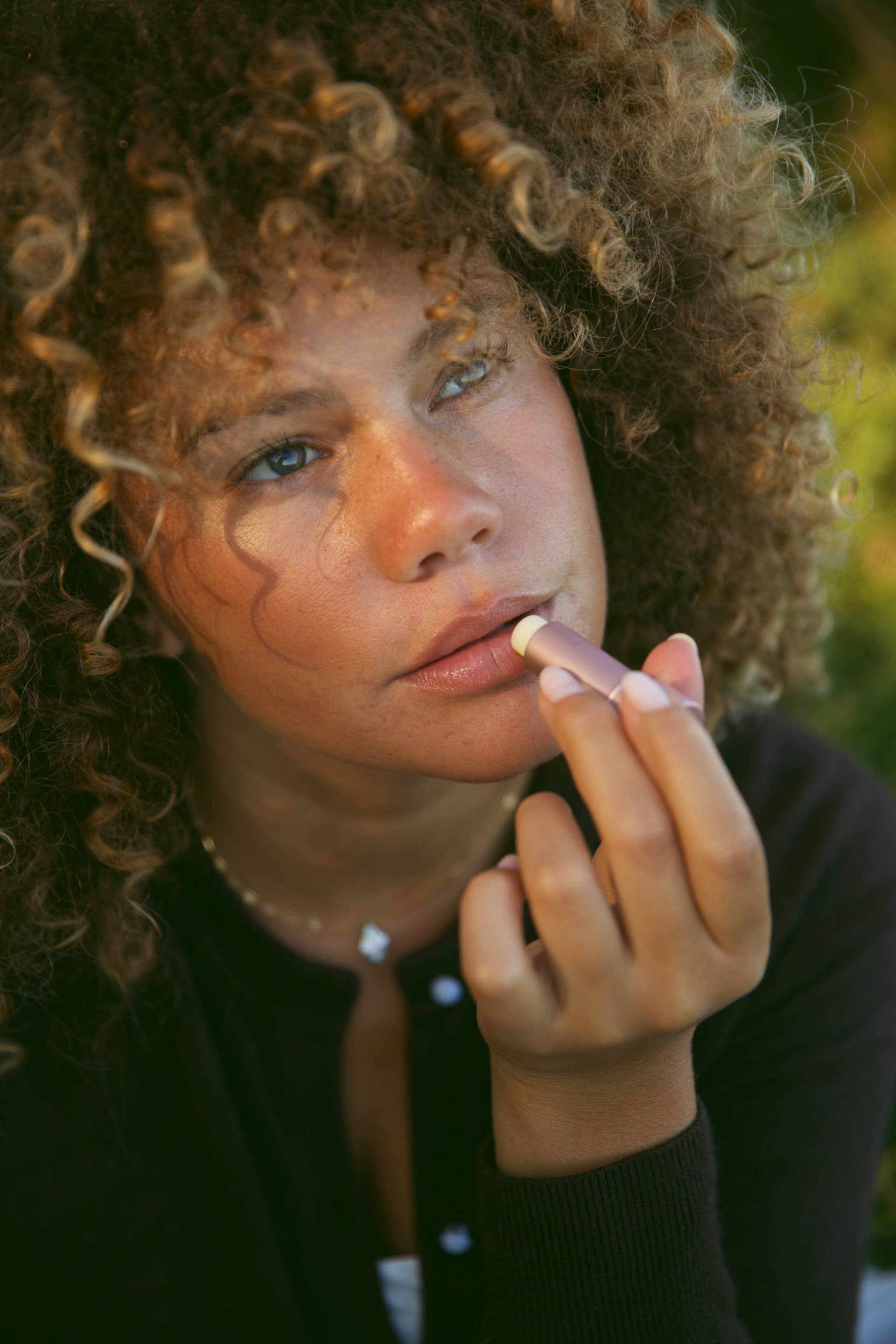 Rose Tallow Lip Balm being applied to lips