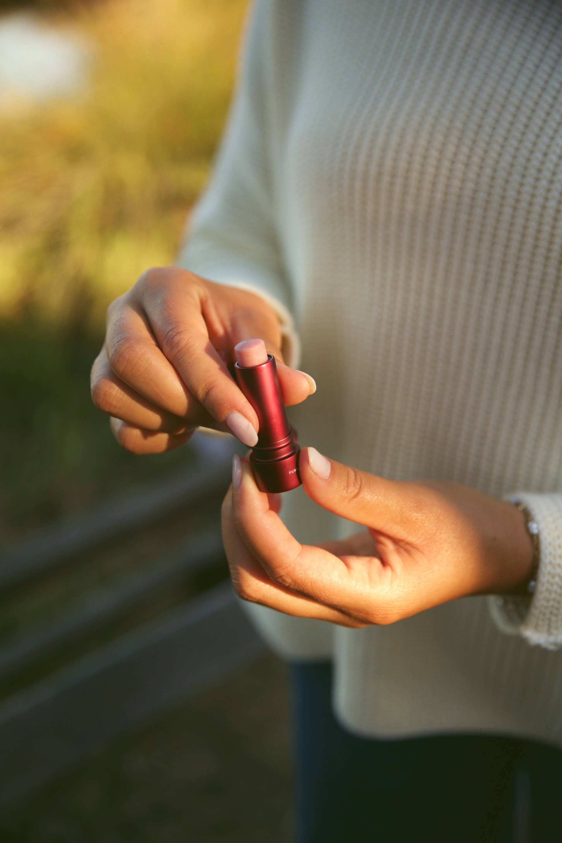 Rose Tallow Lip Balm - TINTED held in a hand