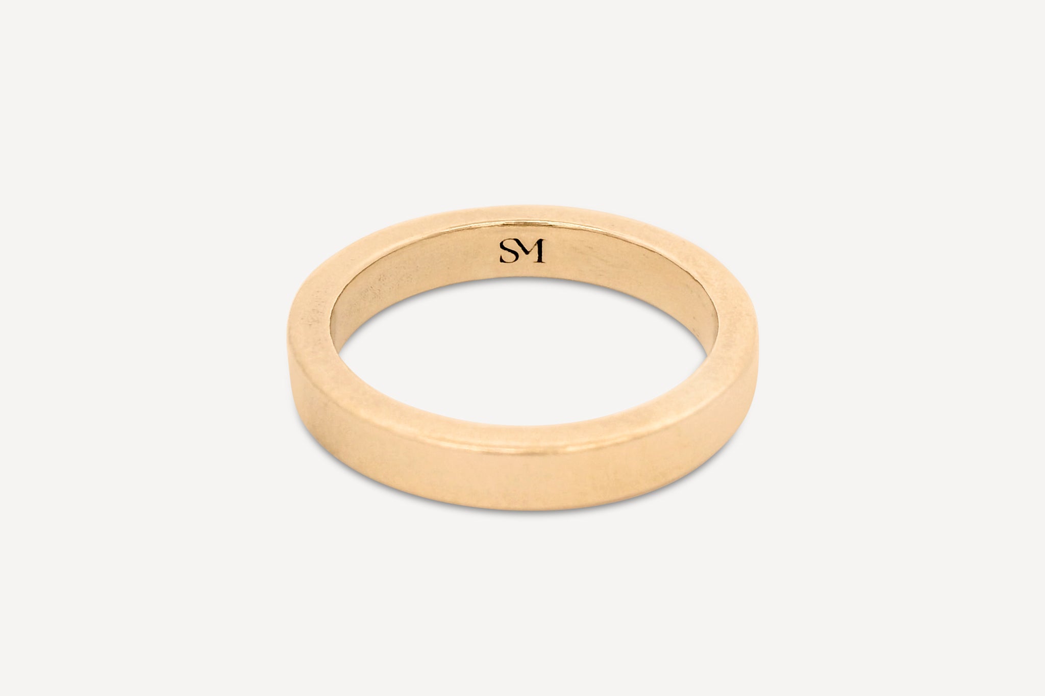 Solid gold everyday band ring with a polished finish on a white background.