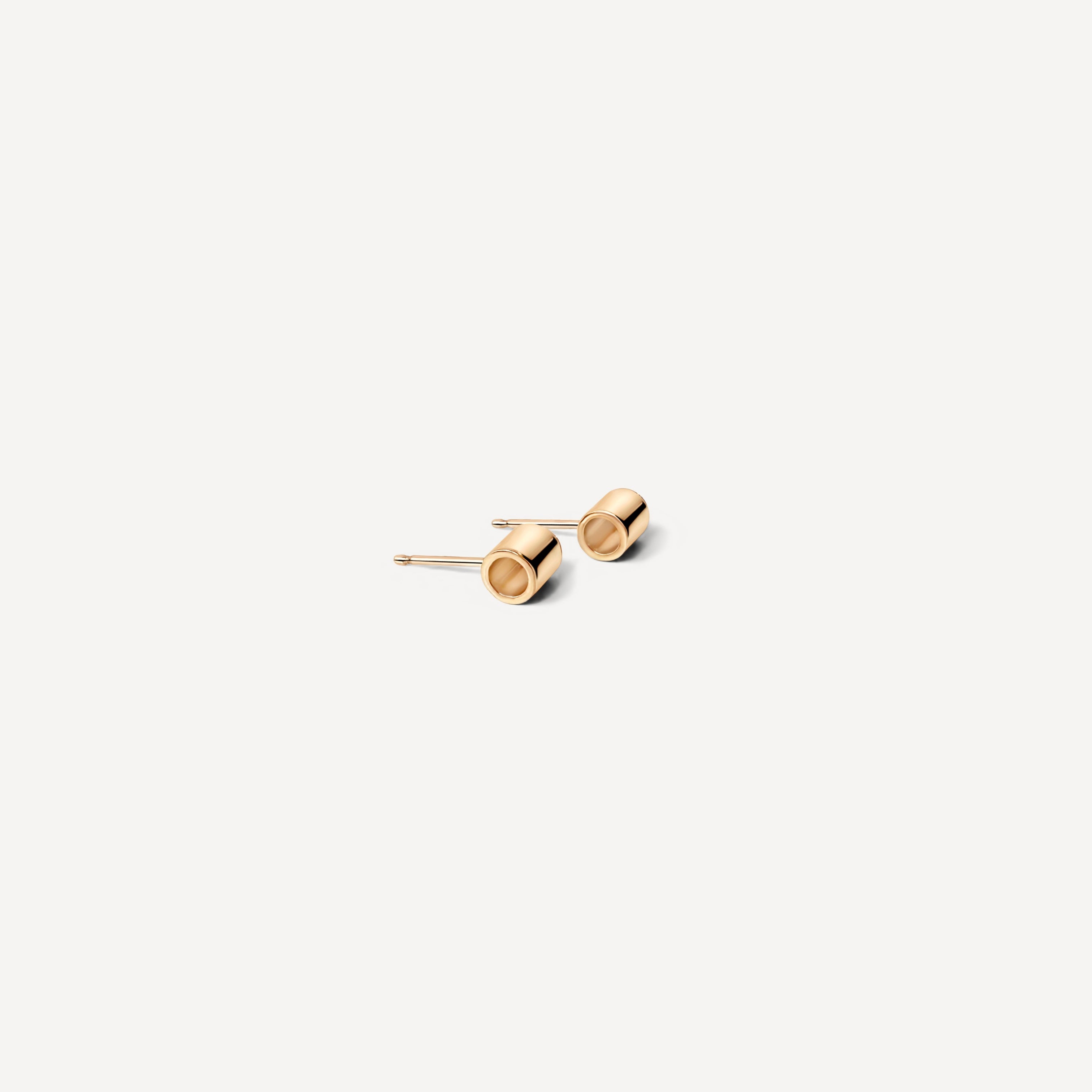 Minimalist gold stud earrings for everyday wear, featuring simple cylinder design perfect for minimal jewelry lovers seeking timeless, dainty gold studs that pair with everything