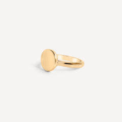 Minimalist solid gold round signet ring by Sheena Marshall Jewelry, showcasing modern and timeless design