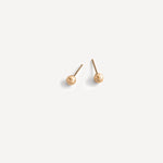 Minimalist Sophie Sphere Stud Earrings in gold fill lying flat on a white background