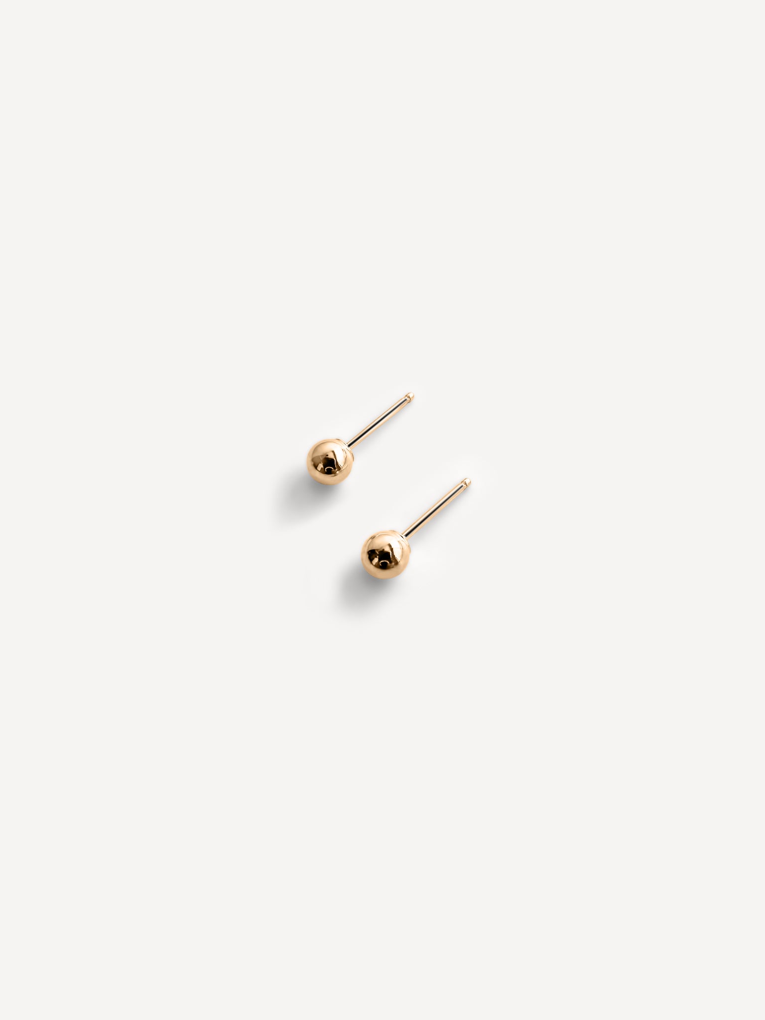 Sophie Sphere Stud Earrings paired with matching minimalist gold jewelry