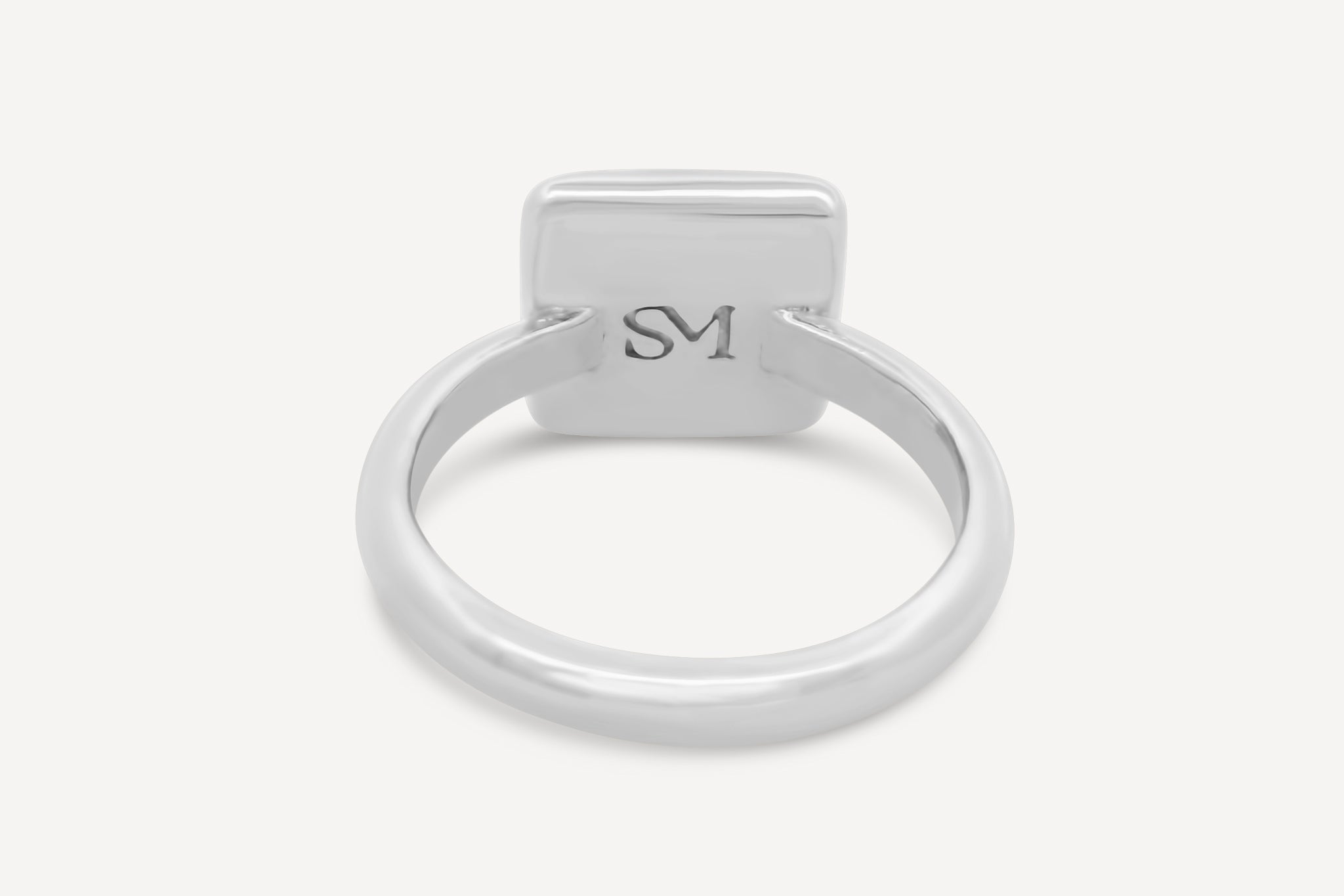 Close-up of the interior of the sterling silver square ring, featuring the stamped SM logo detail.