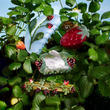Strawberry Garden Snail Fruit Acetate Hair Claw Clip displayed with other snail clips among strawberry leaves
