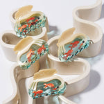 White Swan Hair Claw arranged with other clips