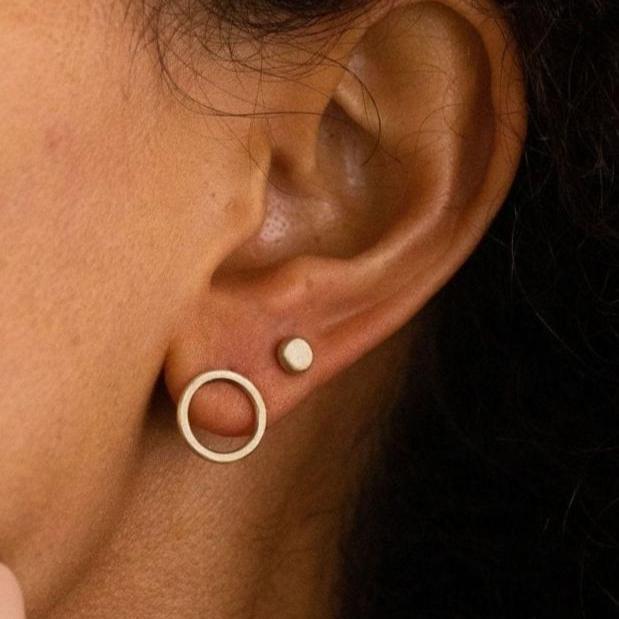 Model wearing handcrafted 14k gold open circle stud earrings by Sheena Marshall Jewelry, showcasing minimalist, heirloom-quality design with timeless appeal.