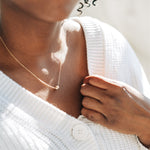lose-up of the Nova Floating Sphere Necklace showing the polished gold fill sphere detail.