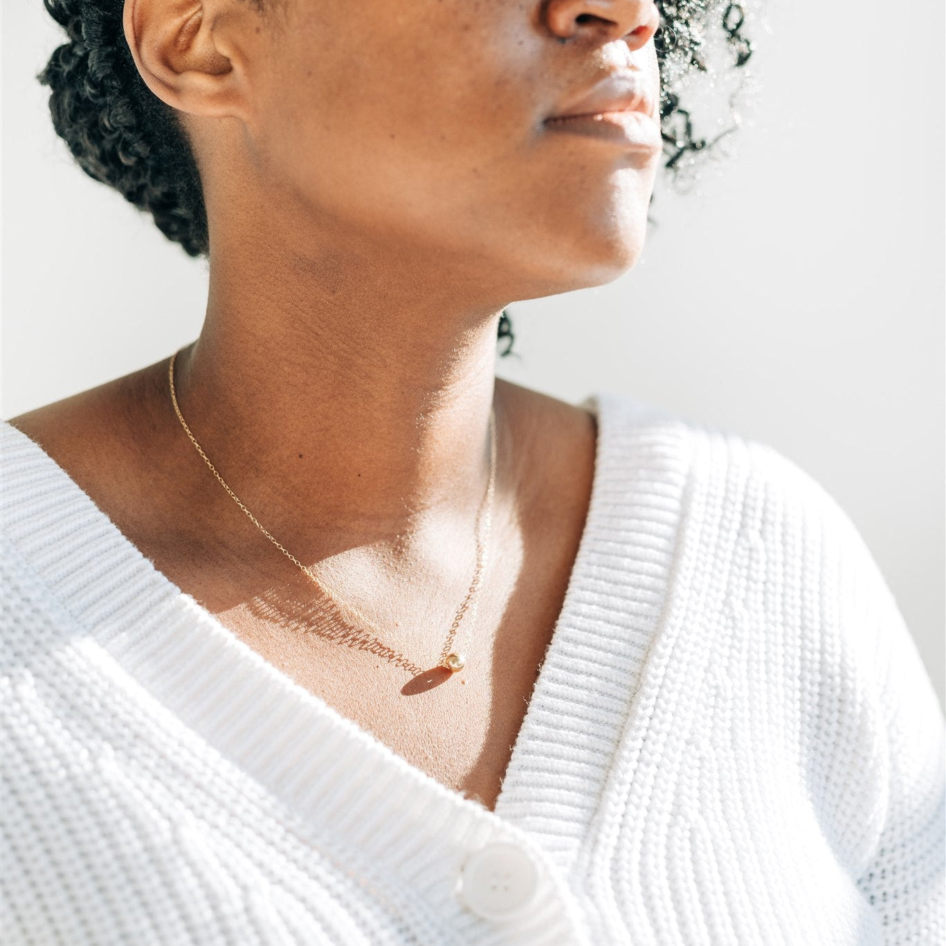 Nova Floating Sphere Necklace being worn, highlighting its elegant and versatile design.