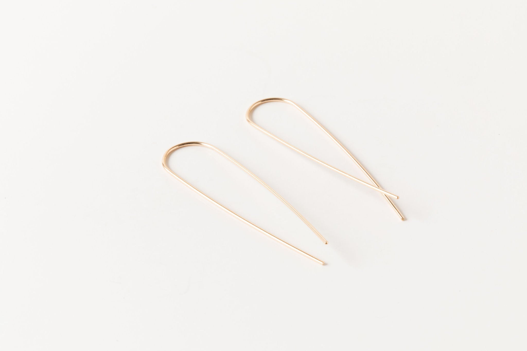 Gold fill long threader earrings with a sleek minimalist design, displayed on a white background.