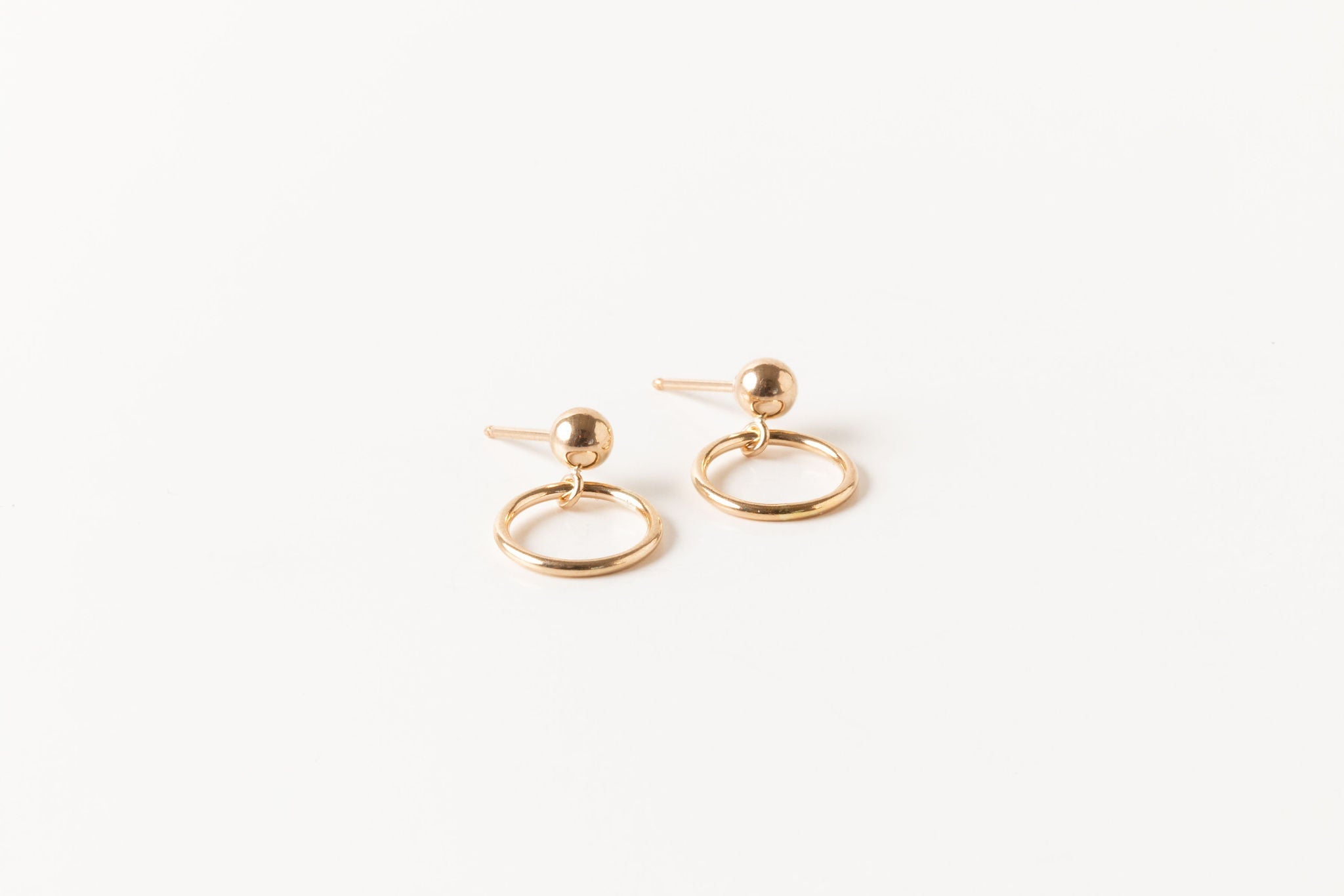 Handcrafted Circlet Earrings by Sheena Marshall Jewelry, featuring 10mm gold-filled circles and ball studs for a minimalist, timeless design. Crafted in Denver.