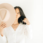 Model wearing Circlet Earrings in gold fill by Sheena Marshall Jewelry, styled with a minimalist look and a hat, showcasing timeless elegance and handcrafted design.