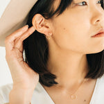 Model wearing handcrafted Circlet Earrings in gold fill by Sheena Marshall Jewelry, showcasing minimalist and timeless design crafted in Denver