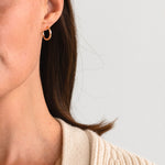 Model wearing handcrafted Clea Hoops in gold fill by Sheena Marshall Jewelry, showcasing a polished, timeless design perfect for everyday elegance.