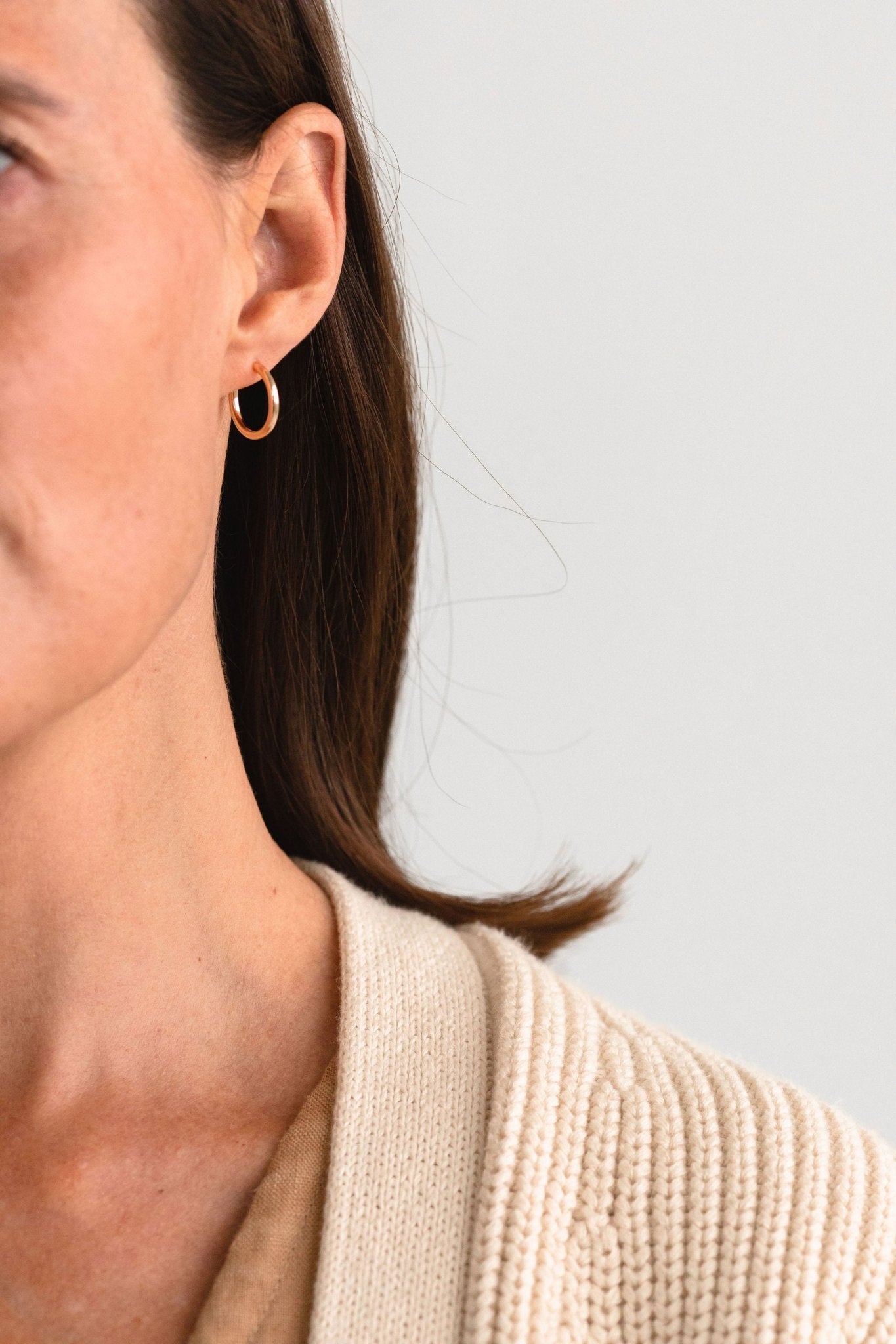 Model wearing handcrafted Clea Hoops in gold fill by Sheena Marshall Jewelry, showcasing a polished, timeless design perfect for everyday elegance.