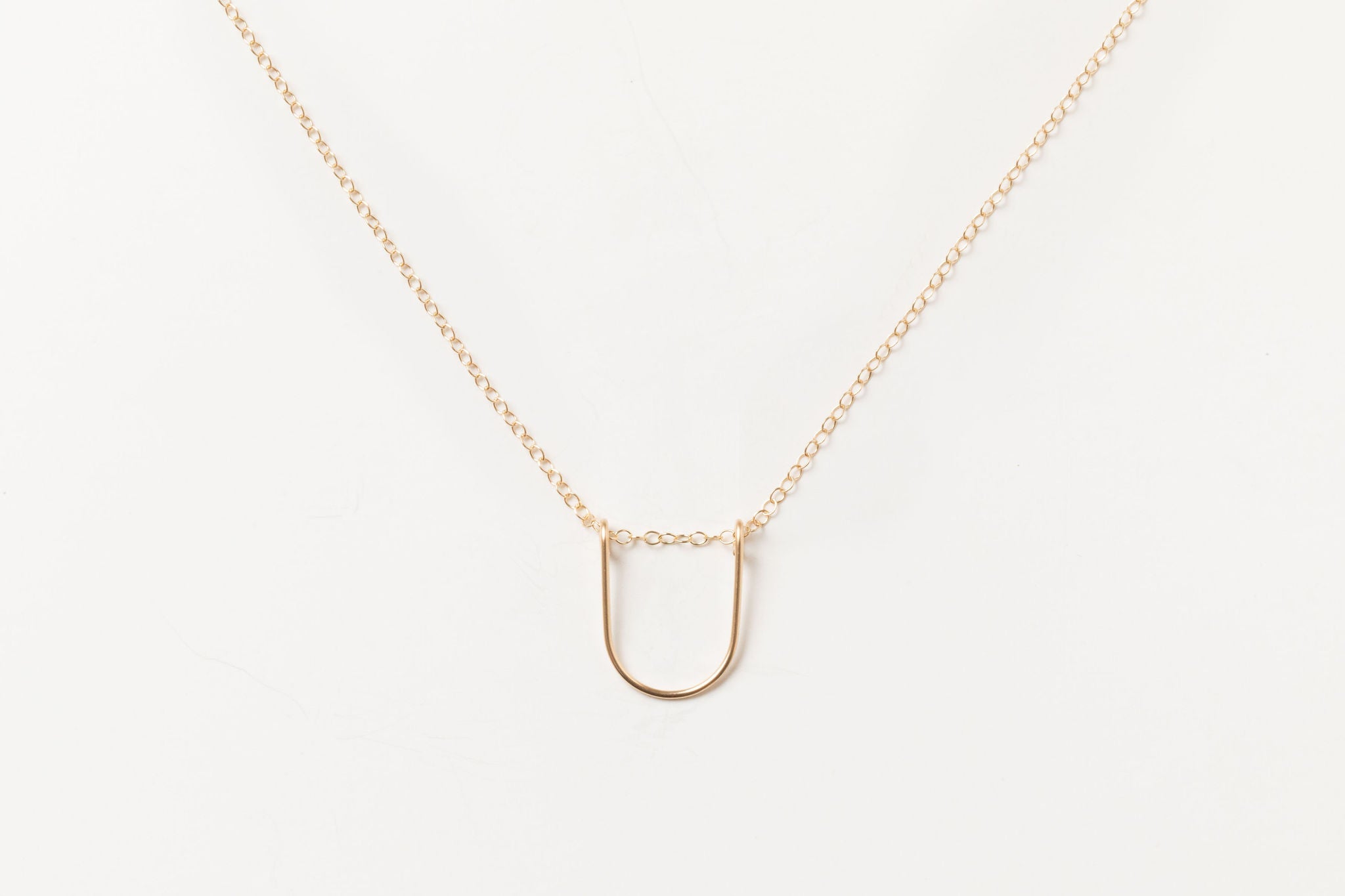 Gold-filled Empower Arch Necklace with delicate cable chain.