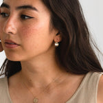 Gold fill Parker Drop Earrings hanging gracefully on model. 