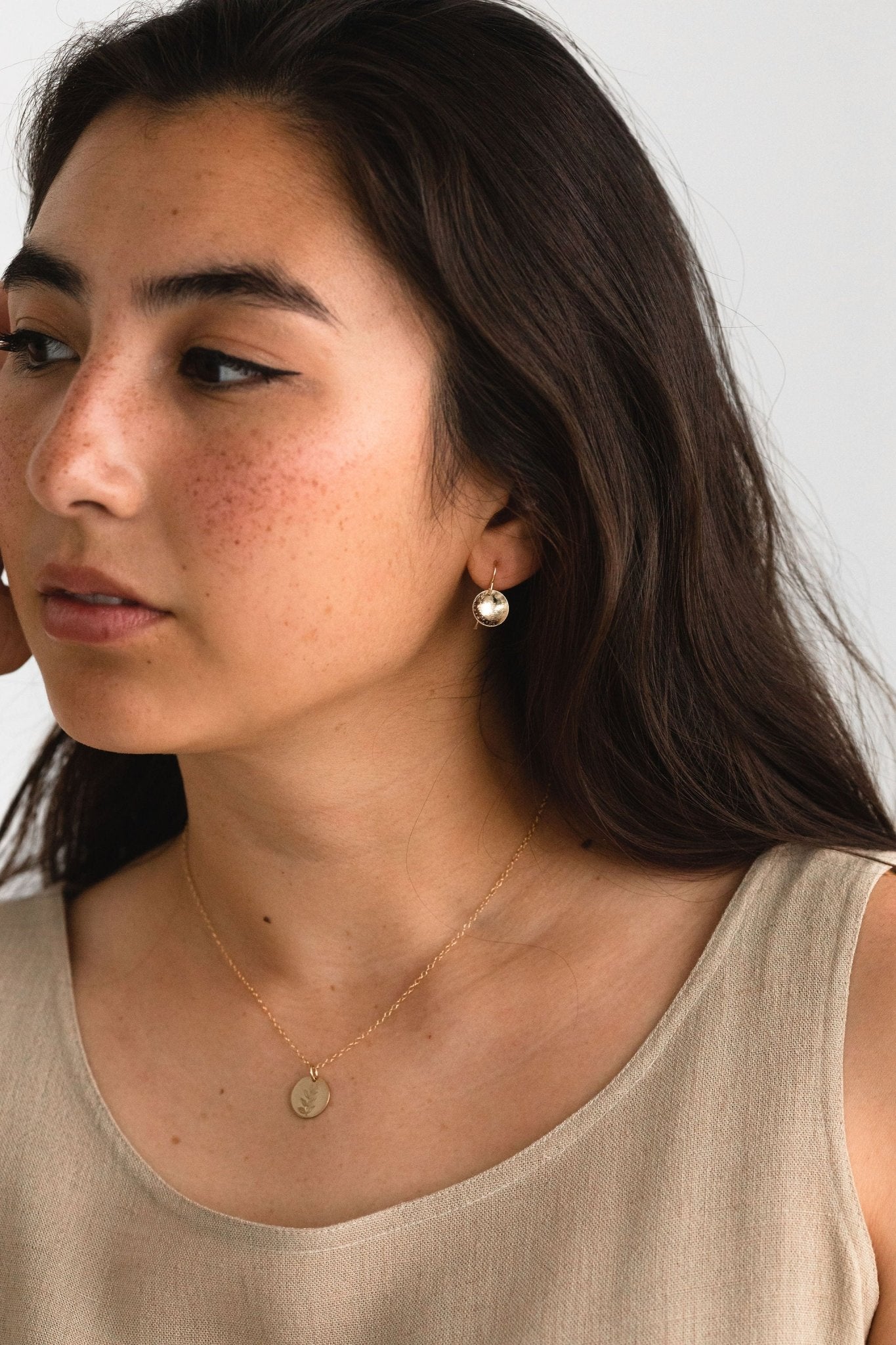 Gold fill Parker Drop Earrings hanging gracefully on model. 