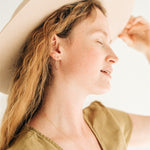 Minimal gold fill hoops on model, showcasing simple elegance.