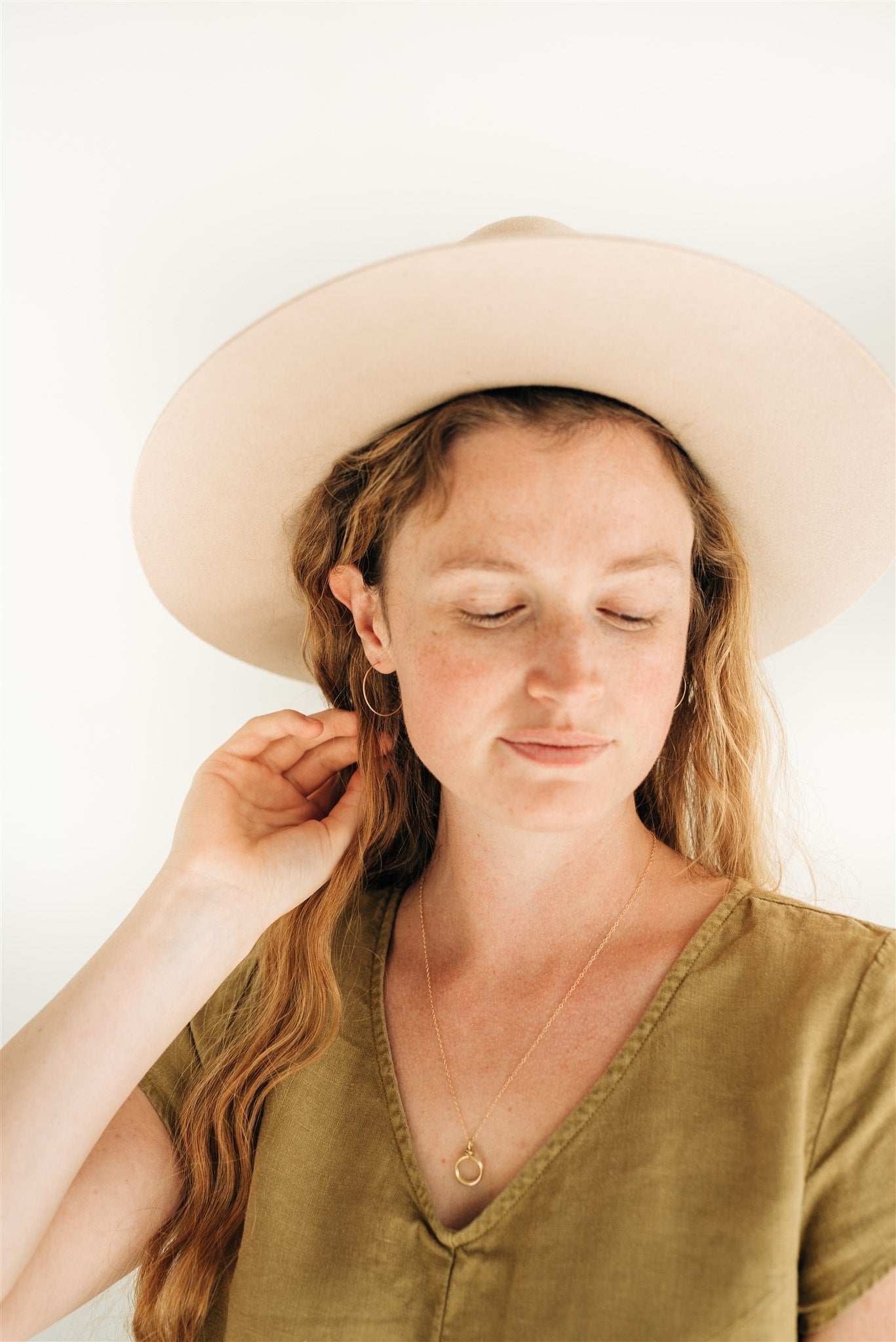 Gold fill hoops worn by model - timeless and versatile earrings.