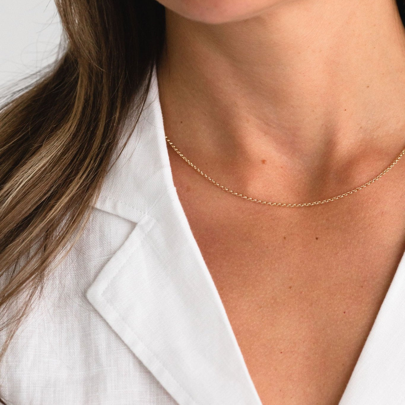 Minimal gold fill necklace worn by a model - lightweight and versatile design.