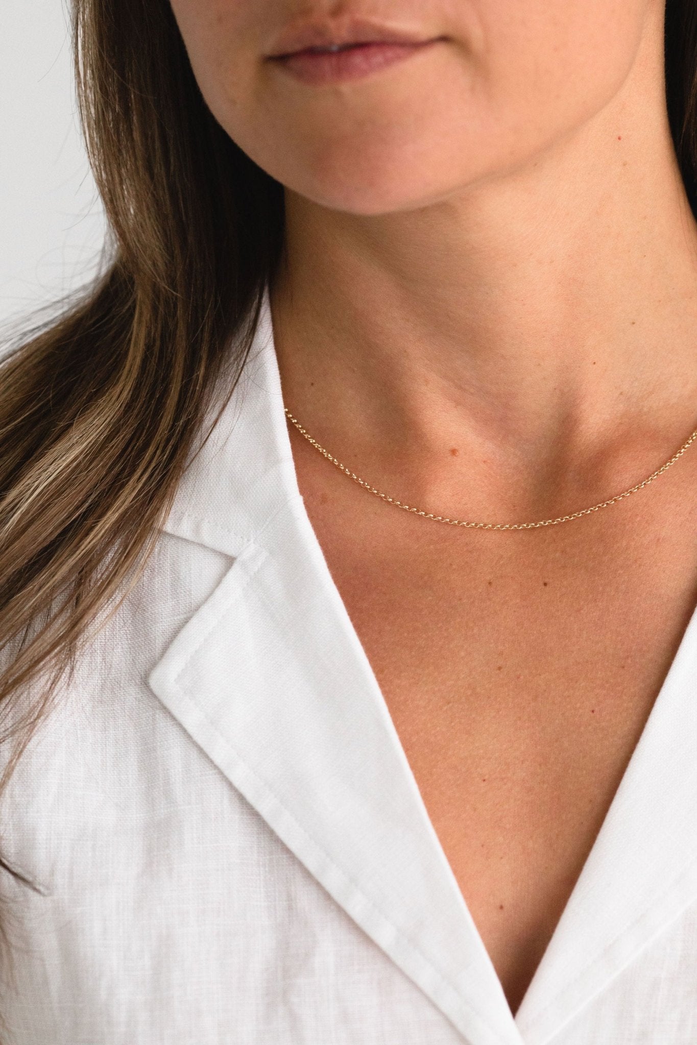 Minimal gold fill necklace worn by a model - lightweight and versatile design.
