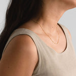 Model wearing the Essential Capsule Satellite Chain Necklace layered with a minimal look.