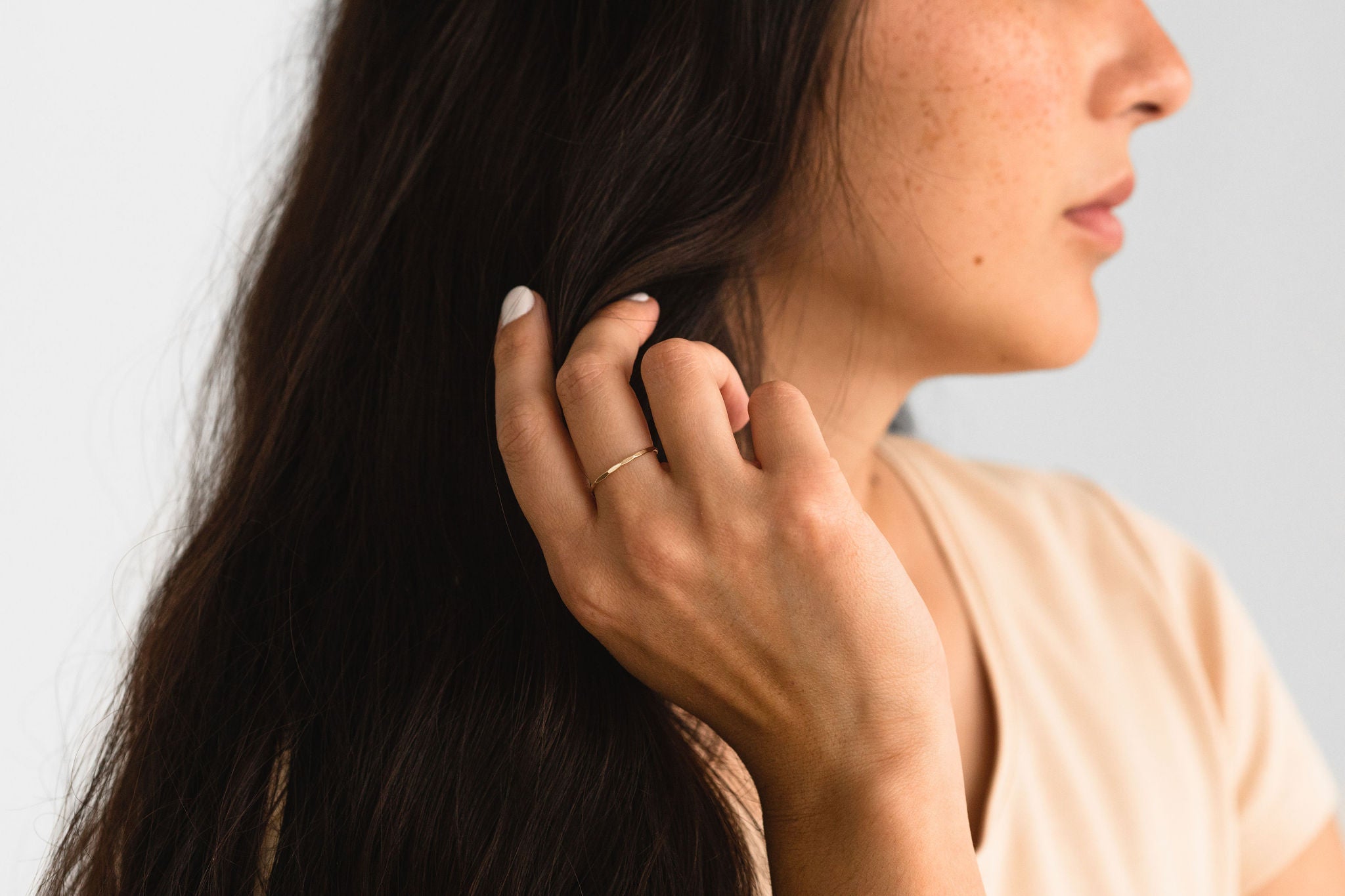 Close-up of the Hammered Ring in gold fill on a hand, highlighting its textured design.