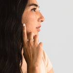 Model wearing the Hammered Ring in gold fill, styled as part of a delicate jewelry stack.