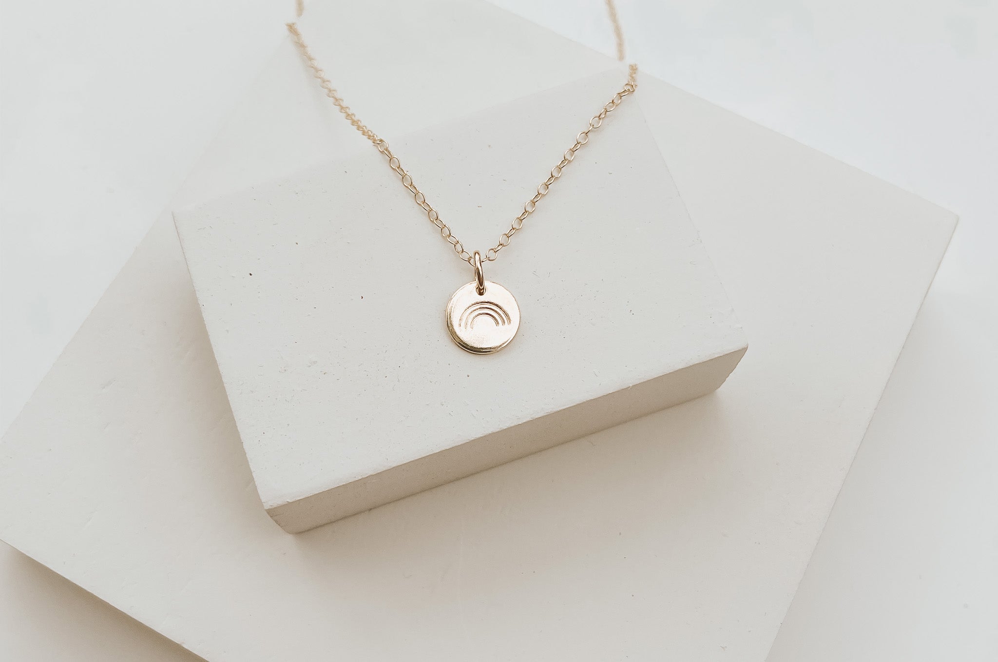 Hope Necklace in gold fill displayed on a clean surface, highlighting its delicate and timeless design.