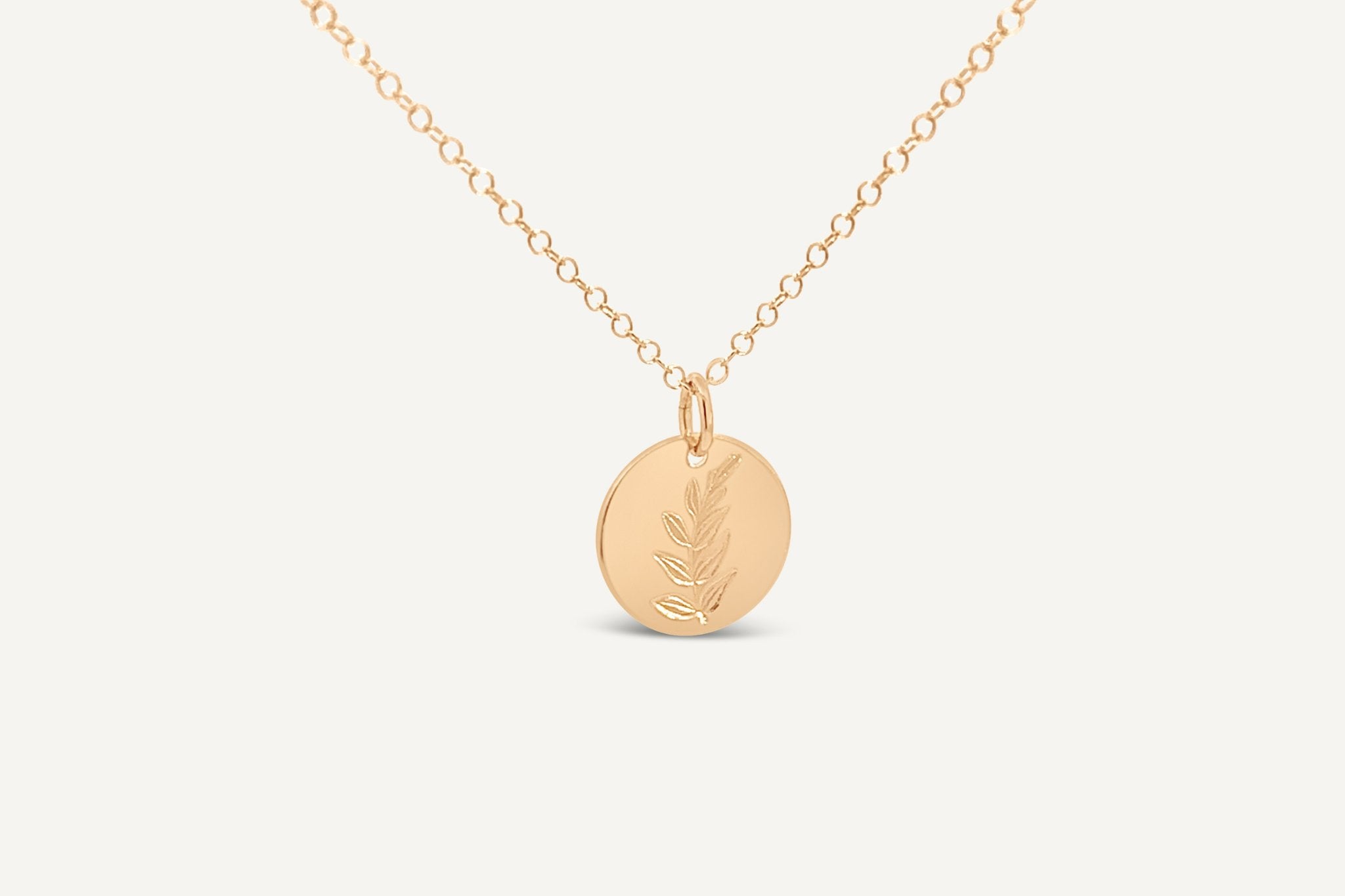 Hygge Bloom Necklace in gold fill featuring a delicate disc pendant, displayed on a white background.