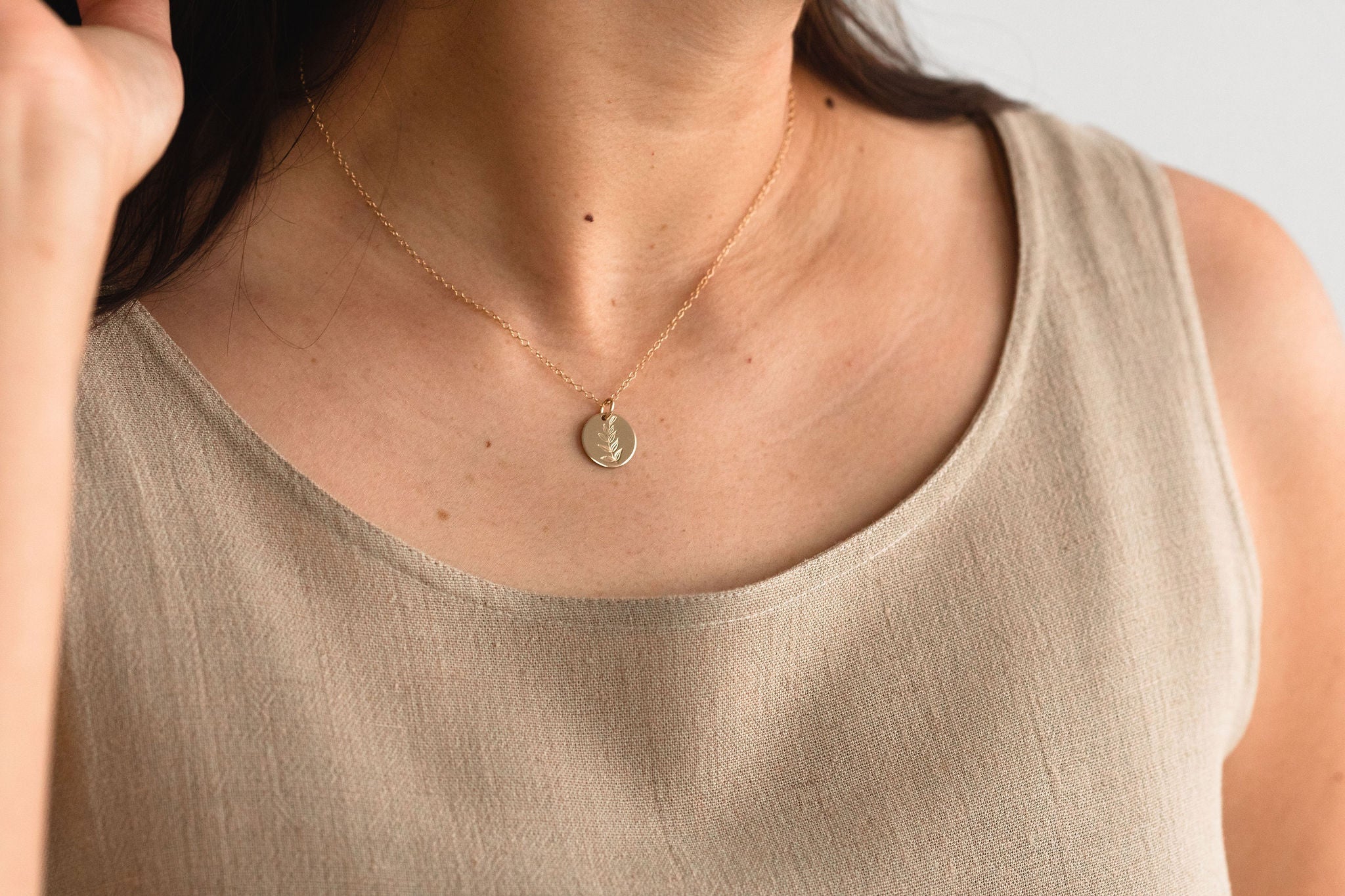 Hygge Bloom Necklace in gold fill displayed with other pieces, highlighting its versatility for everyday wear.