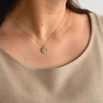 Hygge Bloom Necklace in gold fill displayed with other pieces, highlighting its versatility for everyday wear.